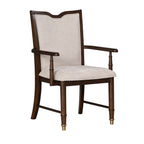 Single transitional dining arm chair with solid wood frame in dark cherry finish and beige cushioned seat and backrest.