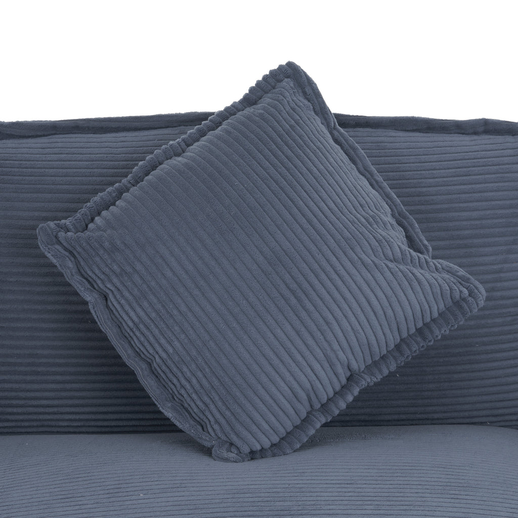 Removable blue corduroy pillow with ribbed texture on the modular sofa. Adds extra comfort and decorative appeal to the seating.