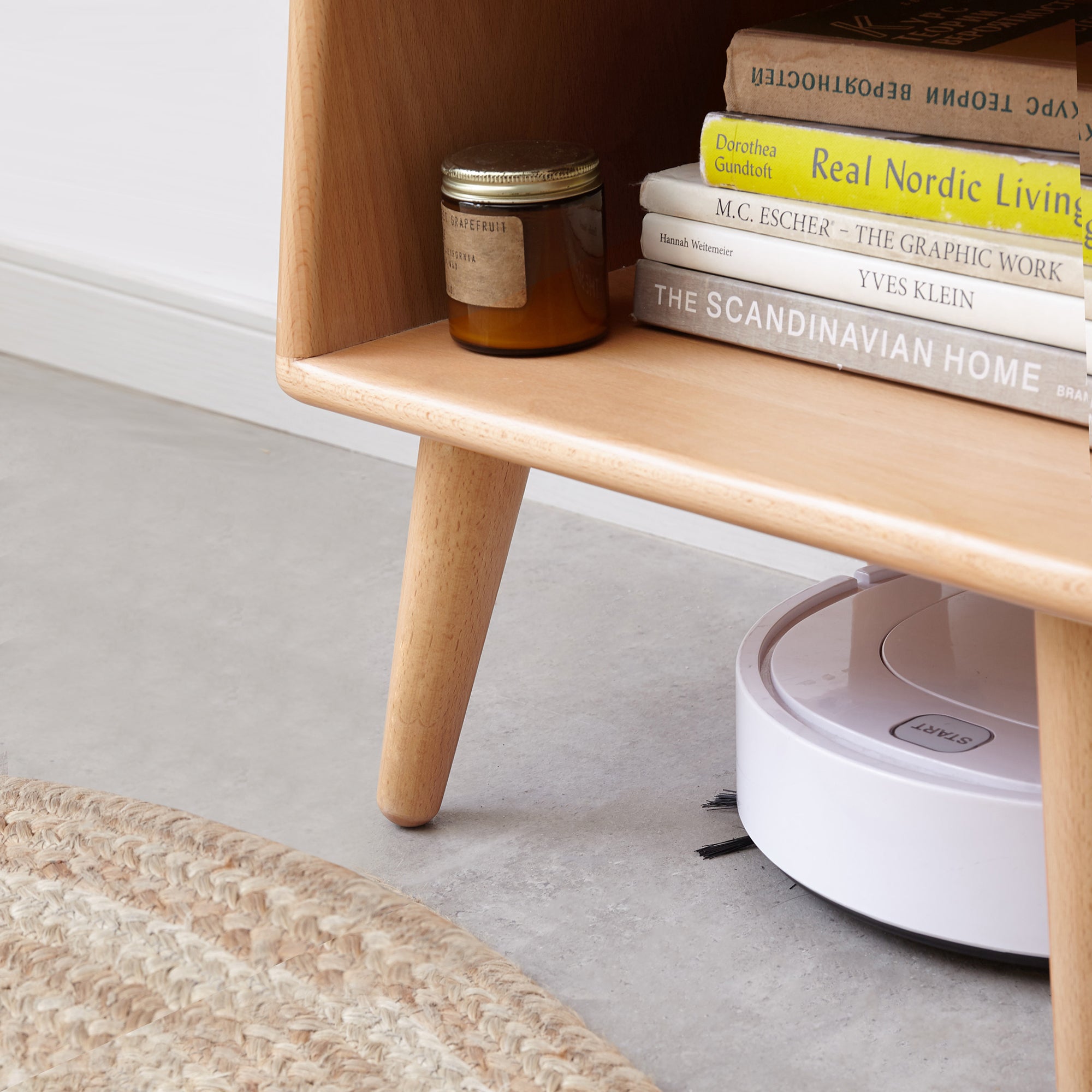 Solid Wood Bedside Cabinet - Nordic Storage with books and decor, showing clearance for robotic vacuum underneath.