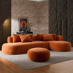 Modern orange oversized L-shape sectional sofa with ottoman in a dark-toned room, offering bold style and spacious seating.