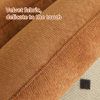 Close-up of velvet fabric on accent chair with solid wood legs, highlighting its soft and delicate texture.