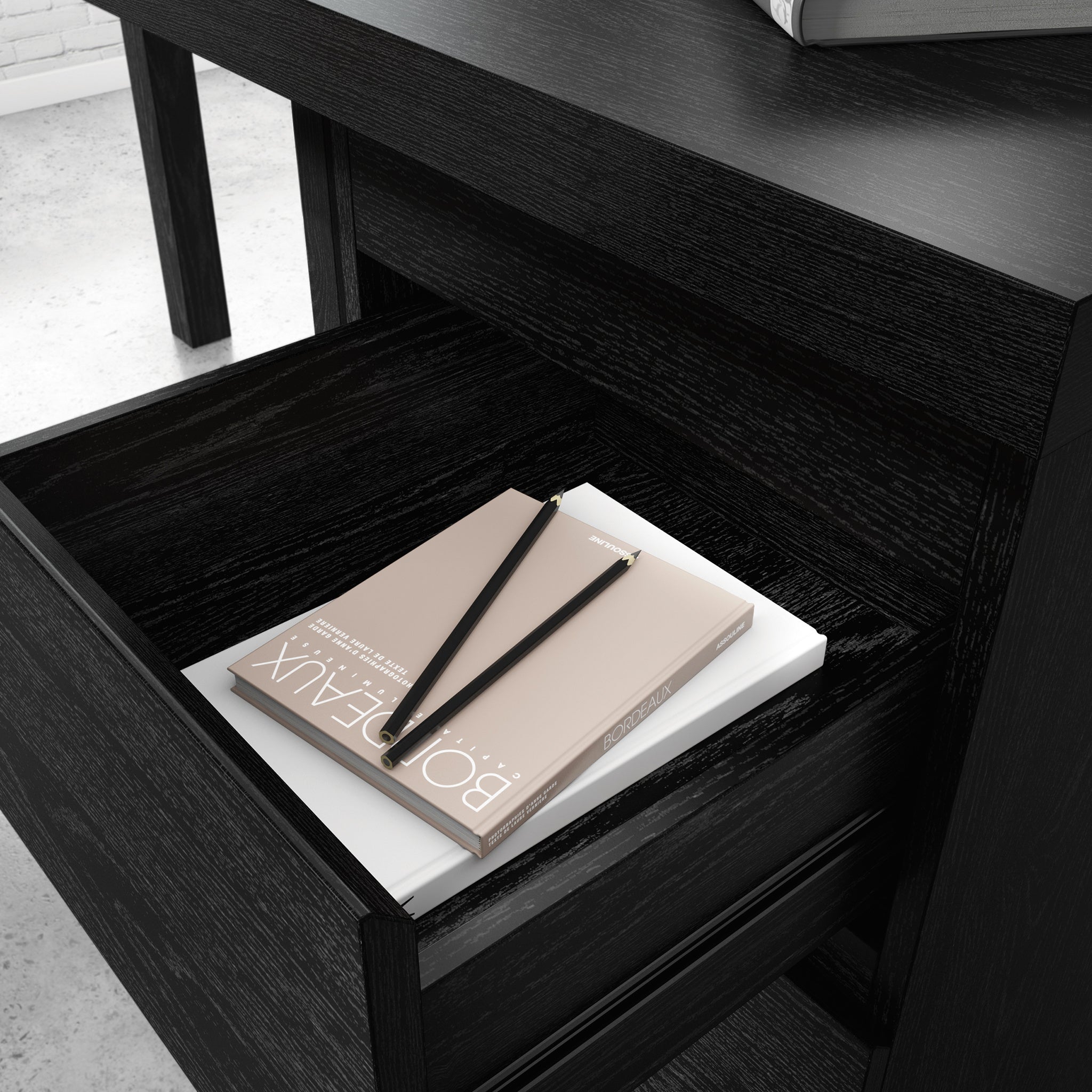 Open drawer of L-Shaped Desk Black Finish revealing storage space for office supplies, enhancing workspace organization.