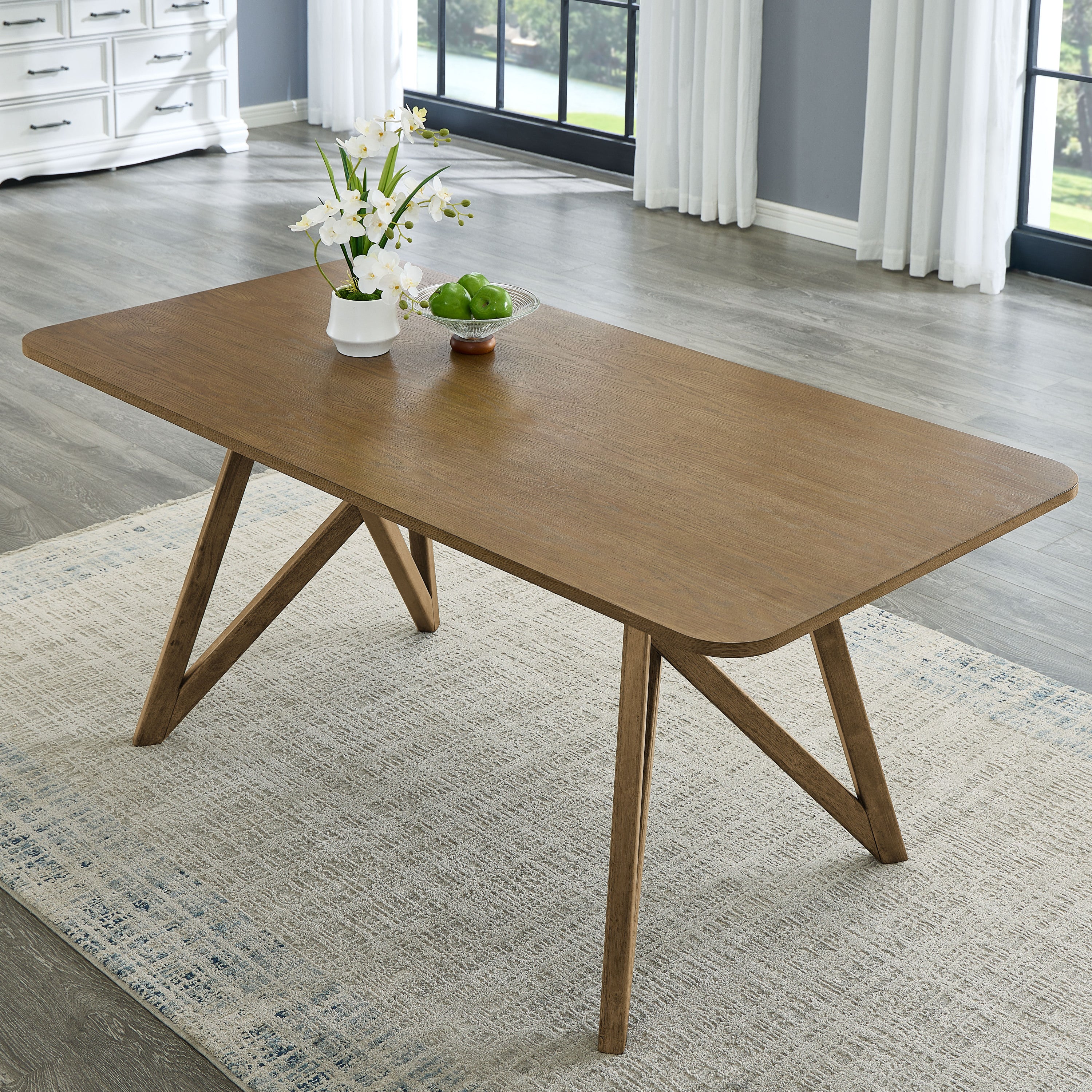 Close-up of Walnut Oak dining table with geometric cross base on rug, highlighting wood grain and sturdy modern design for stylish dining rooms.