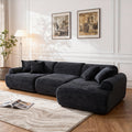 Modern black corduroy modular sectional sofa with L-shaped design, thick cushions, and matching throw pillows.