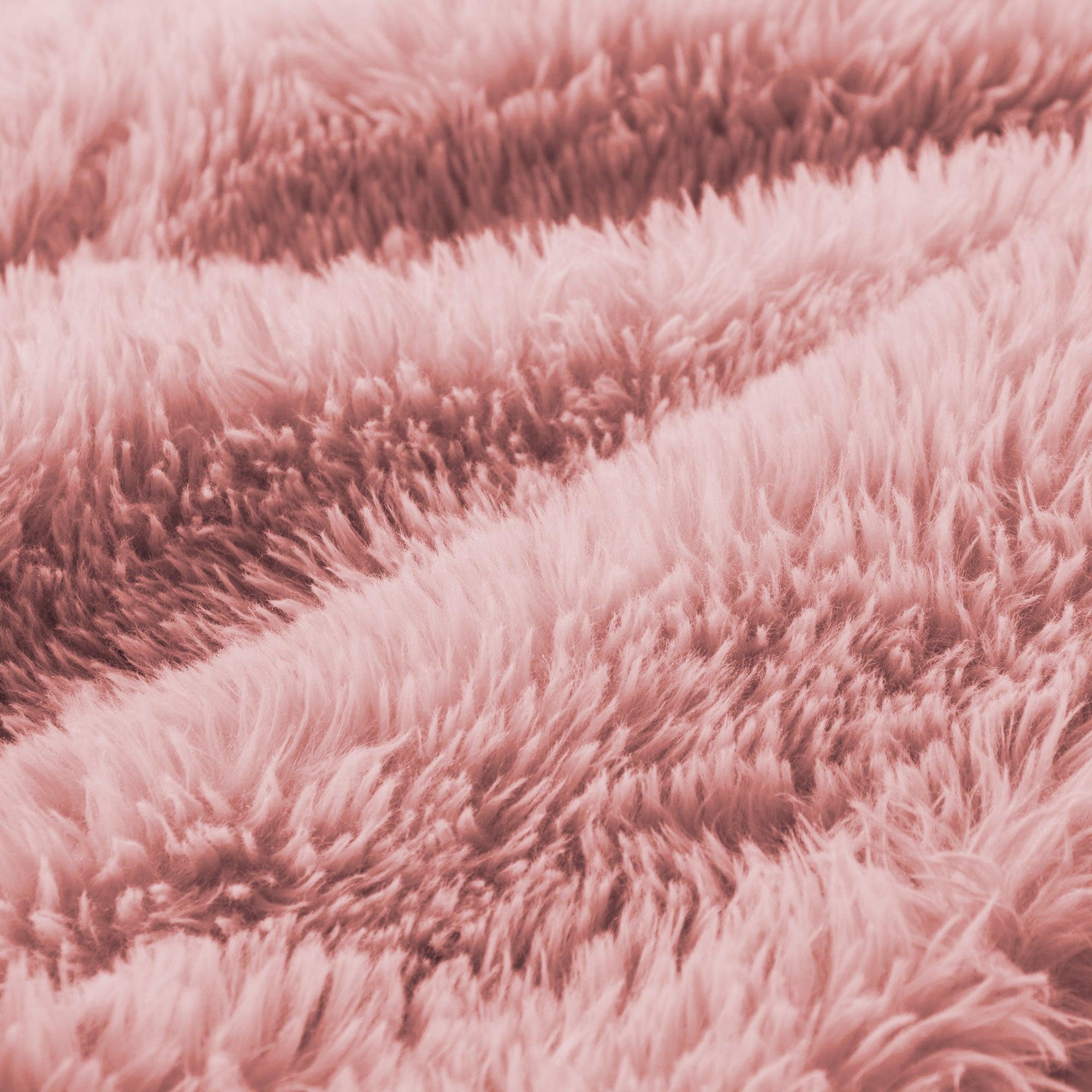 Detailed view of pink plush upholstery on modular sofa, highlighting the thick, fluffy texture for maximum comfort and warmth.
