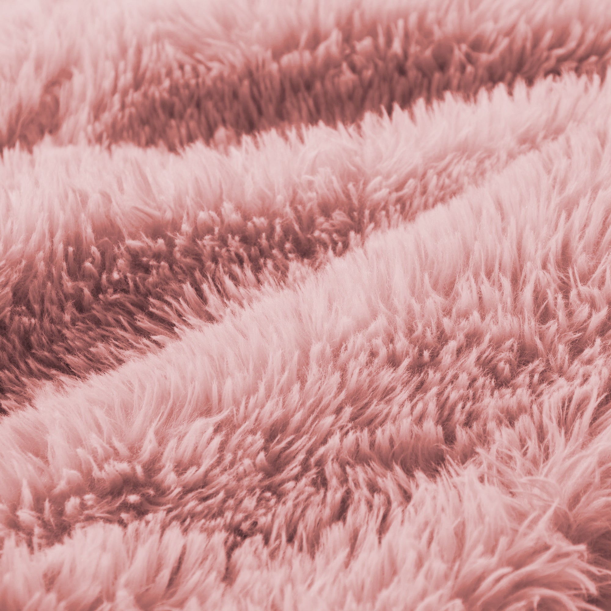 Detailed view of fluffy pink plush fabric used in modular sofa, emphasizing softness and comfort in ergonomic furniture design.