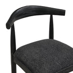 Close-up of black fabric bar stool backrest and seat, showing smooth wood finish and plush upholstery for added comfort.