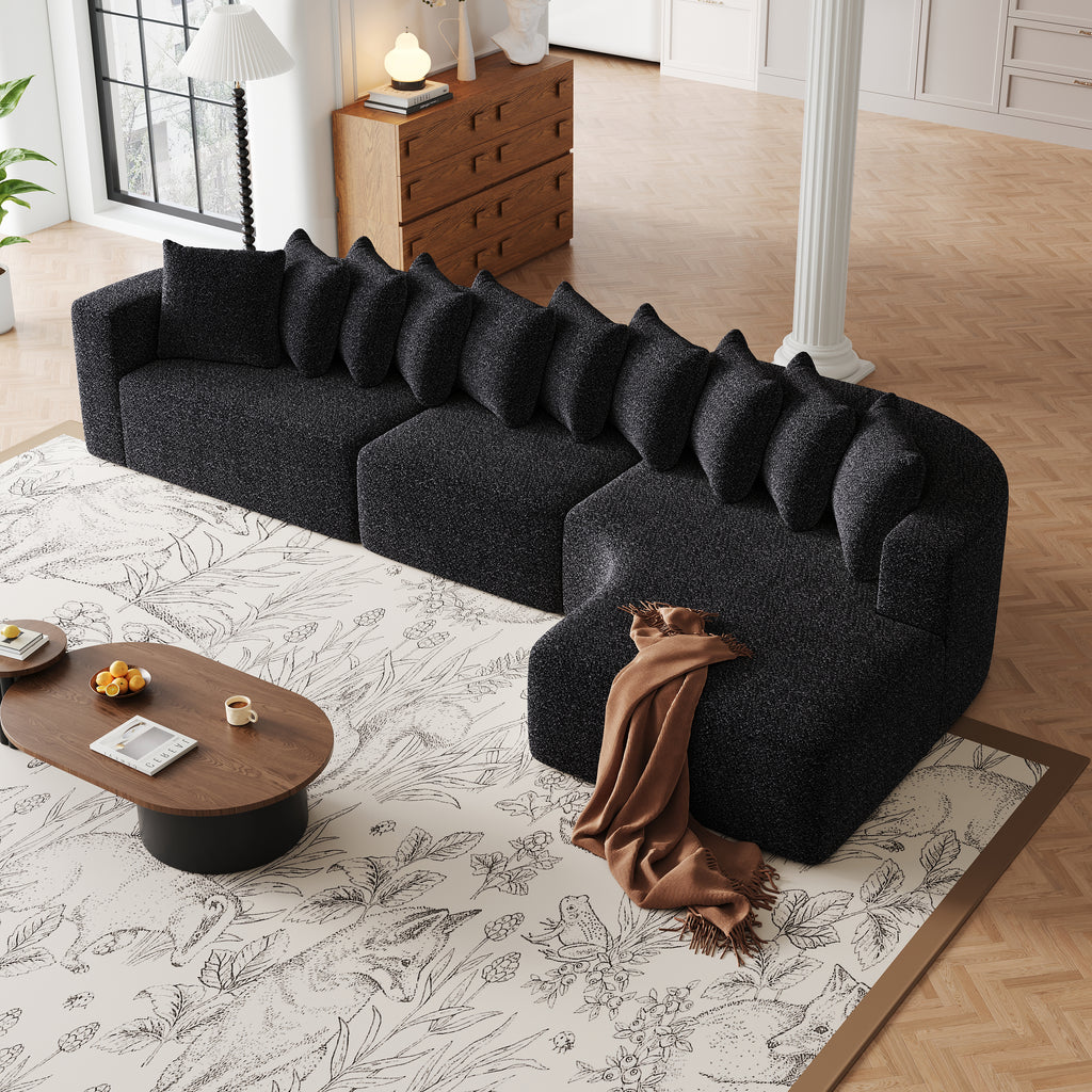 Chenille Sectional Sofa - Modular L-Shaped Sofa in black with 10 pillows and a brown throw, arranged in a cozy corner of a modern living room.