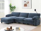 Living room setup featuring modular sectional sofa with USB charger and ottoman. Blue fabric upholstery complements minimalist decor.