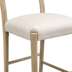 Detailed view of seat corner and leg joint on counter stool. Emphasizes sturdy construction and clean upholstery stitching.