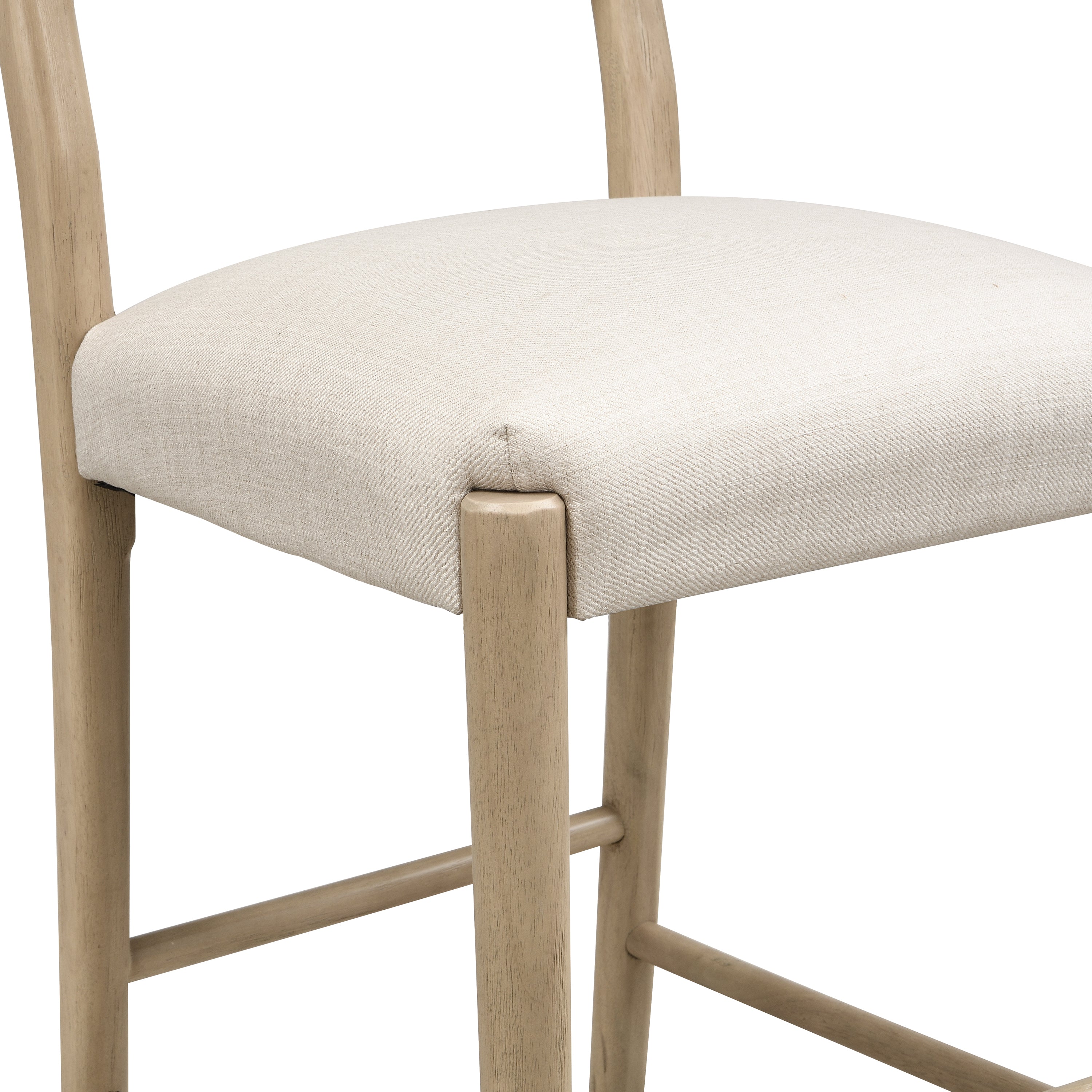 Detailed view of seat corner and leg joint on counter stool. Emphasizes sturdy construction and clean upholstery stitching.