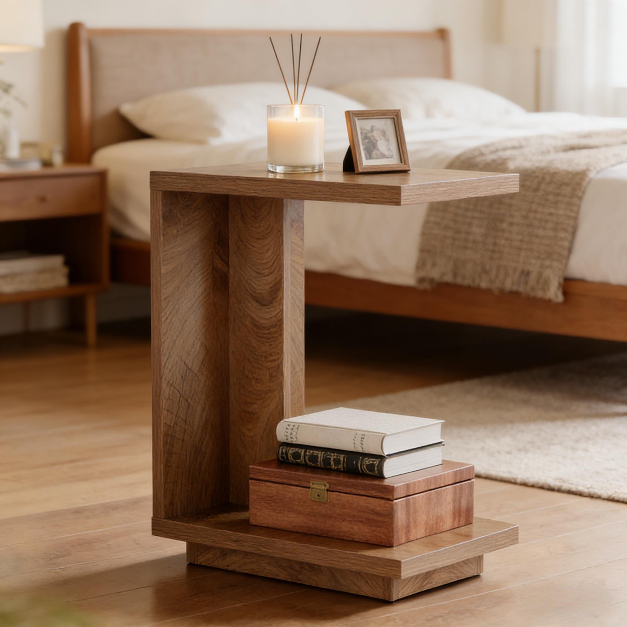 Modern C-shaped wooden bedside table in a warm oak finish, featuring a sleek, minimalist design in a cozy bedroom.