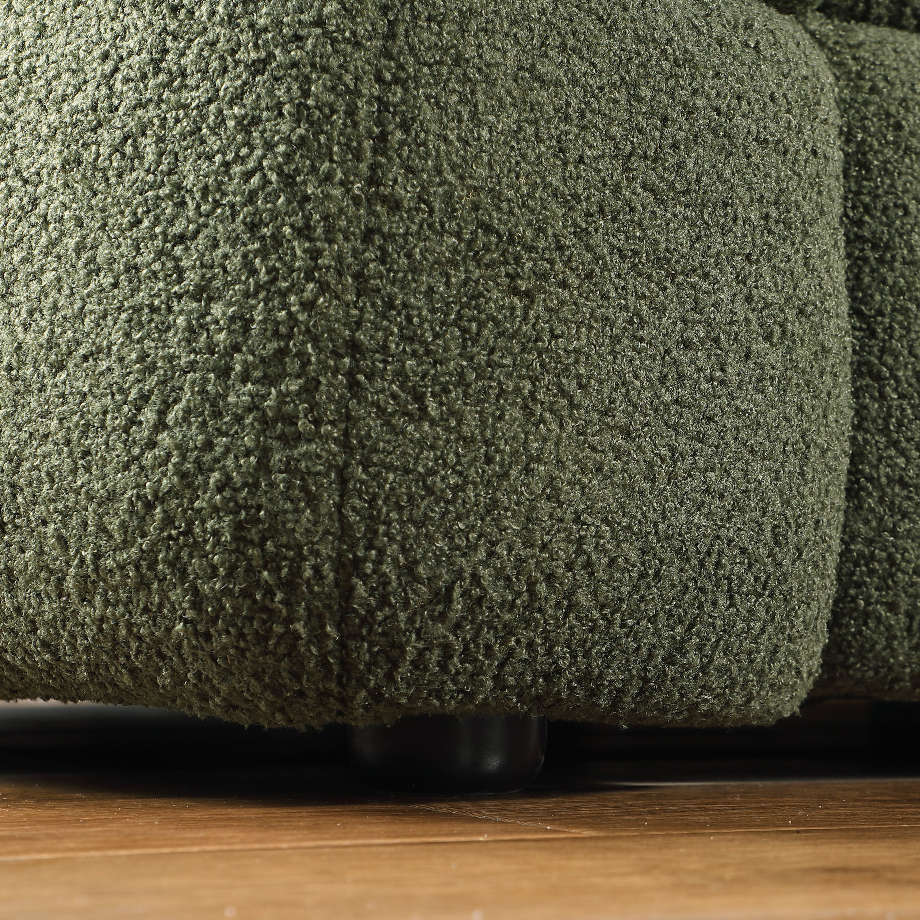 Close-up of sofa leg and base of Olive Green Boucle Sofa - 3 Seater, Marshmallow Cozy with textured boucle upholstery.