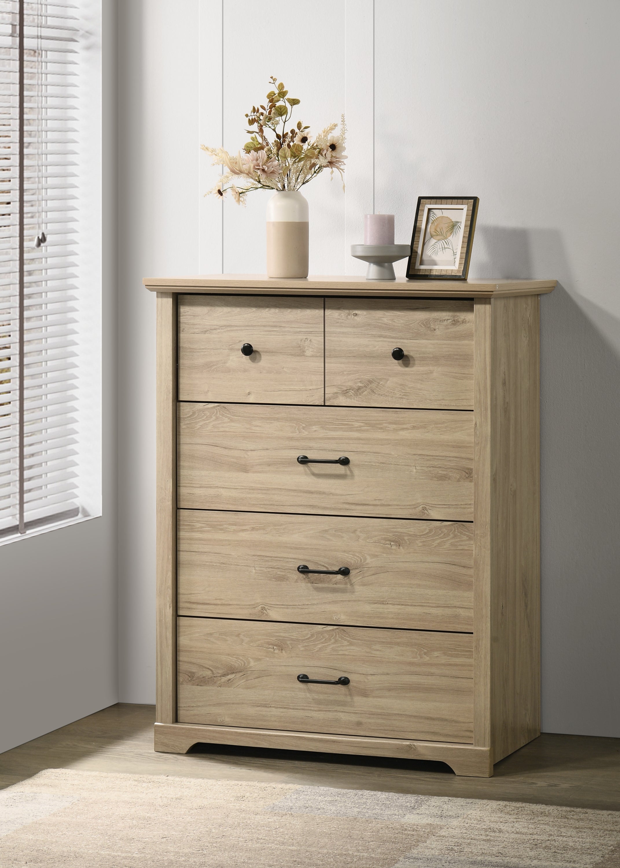 Elara Oak 4-Drawer Chest - Sleek Storage Solution with black handles, styled in a modern bedroom corner with decor on top.