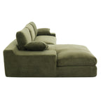 Side profile of green corduroy sofa with chaise and pillows, emphasizing its thick foam cushions and contemporary silhouette.