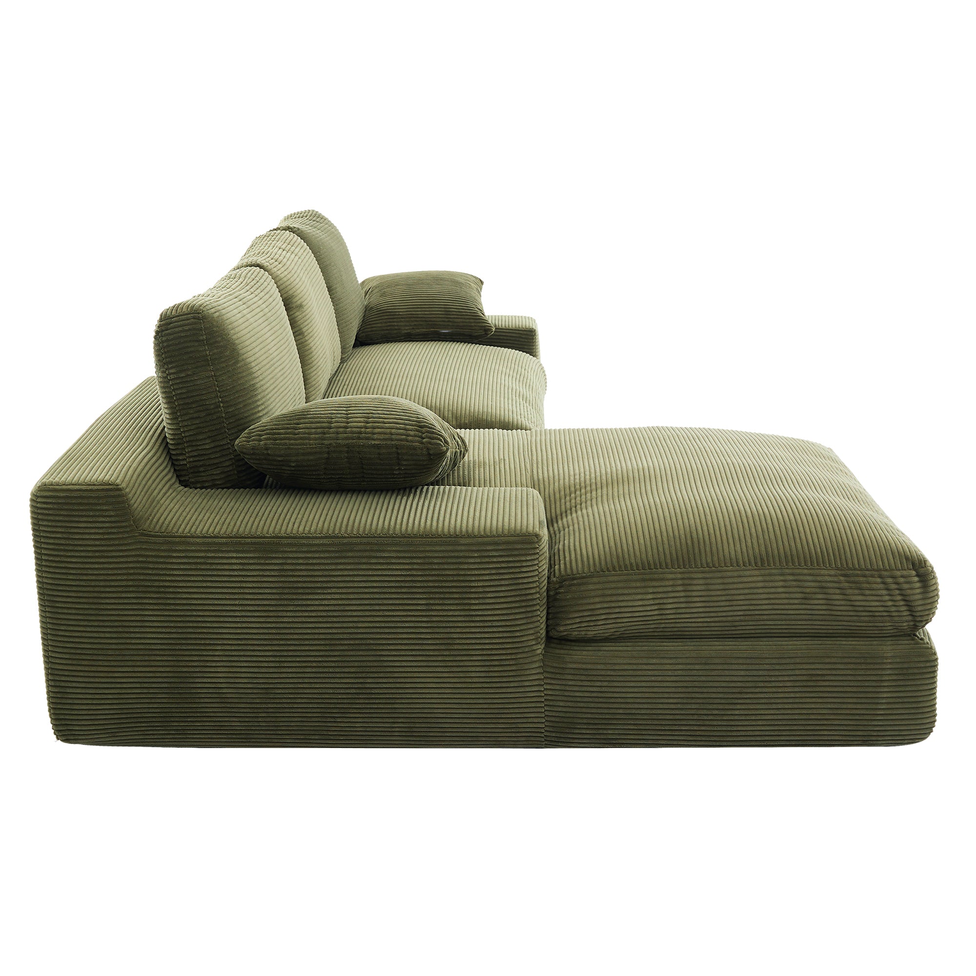 Side profile of green corduroy sofa with chaise and pillows, emphasizing its thick foam cushions and contemporary silhouette.