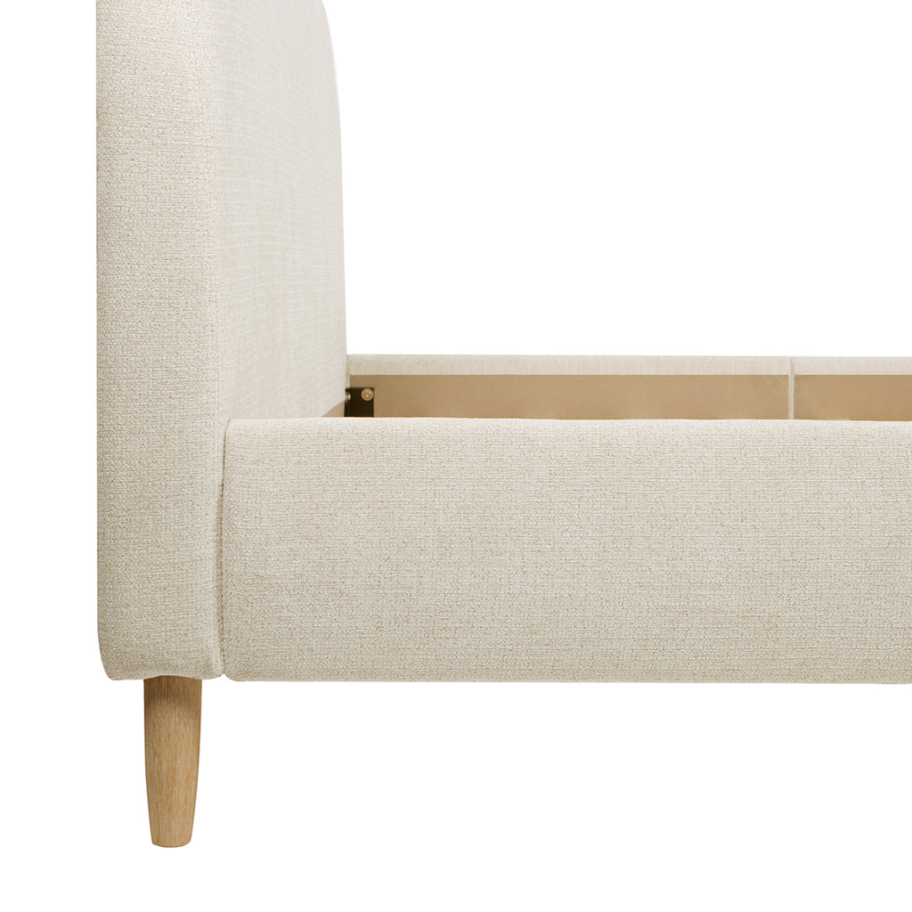 Detail of Platform Bed - Beige Upholstered Curved Headboard corner and leg, emphasizing craftsmanship and natural wood finish.