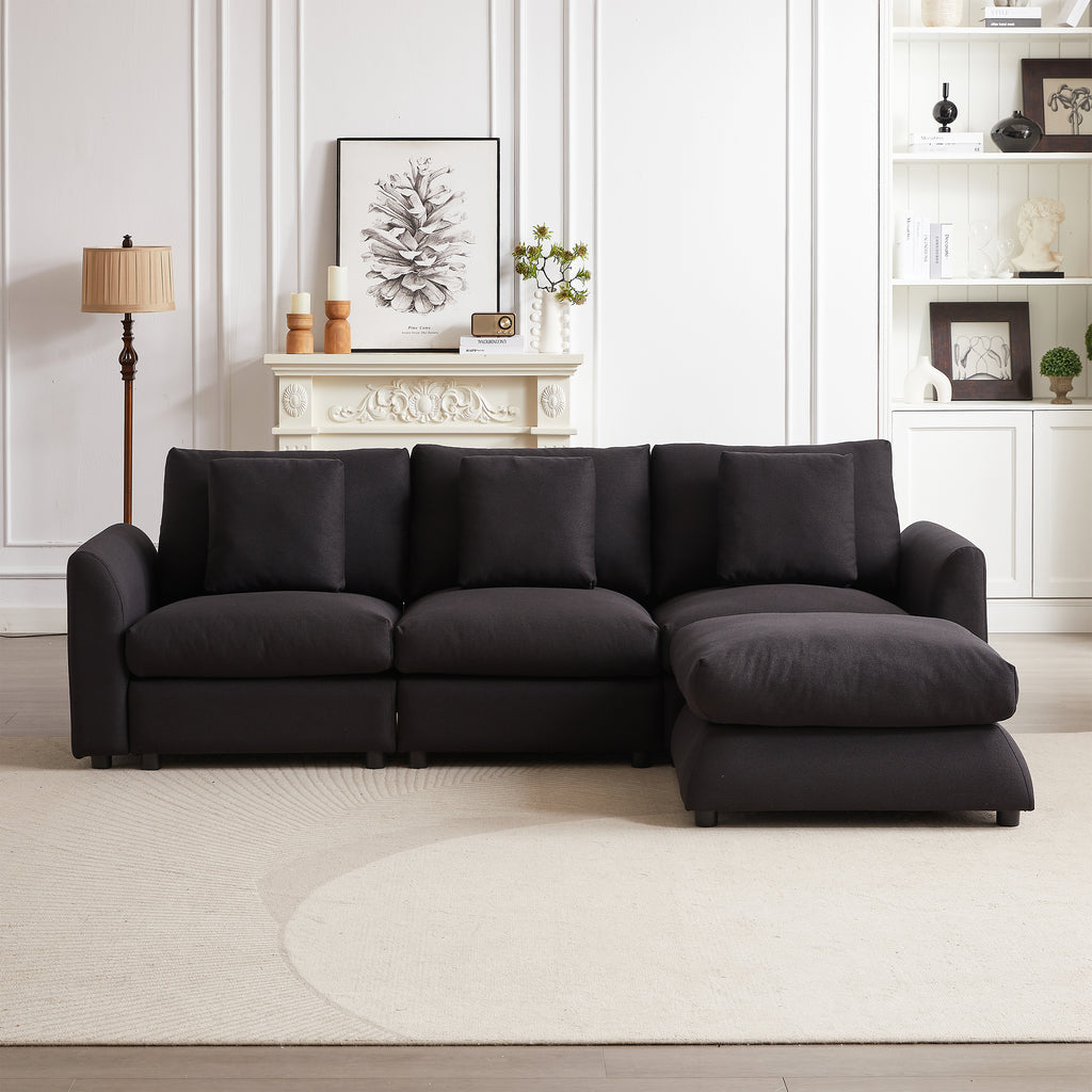 L-shaped modular sofa sleeper with ottoman and 3 pillows, styled in a cozy living room with neutral decor and fireplace.