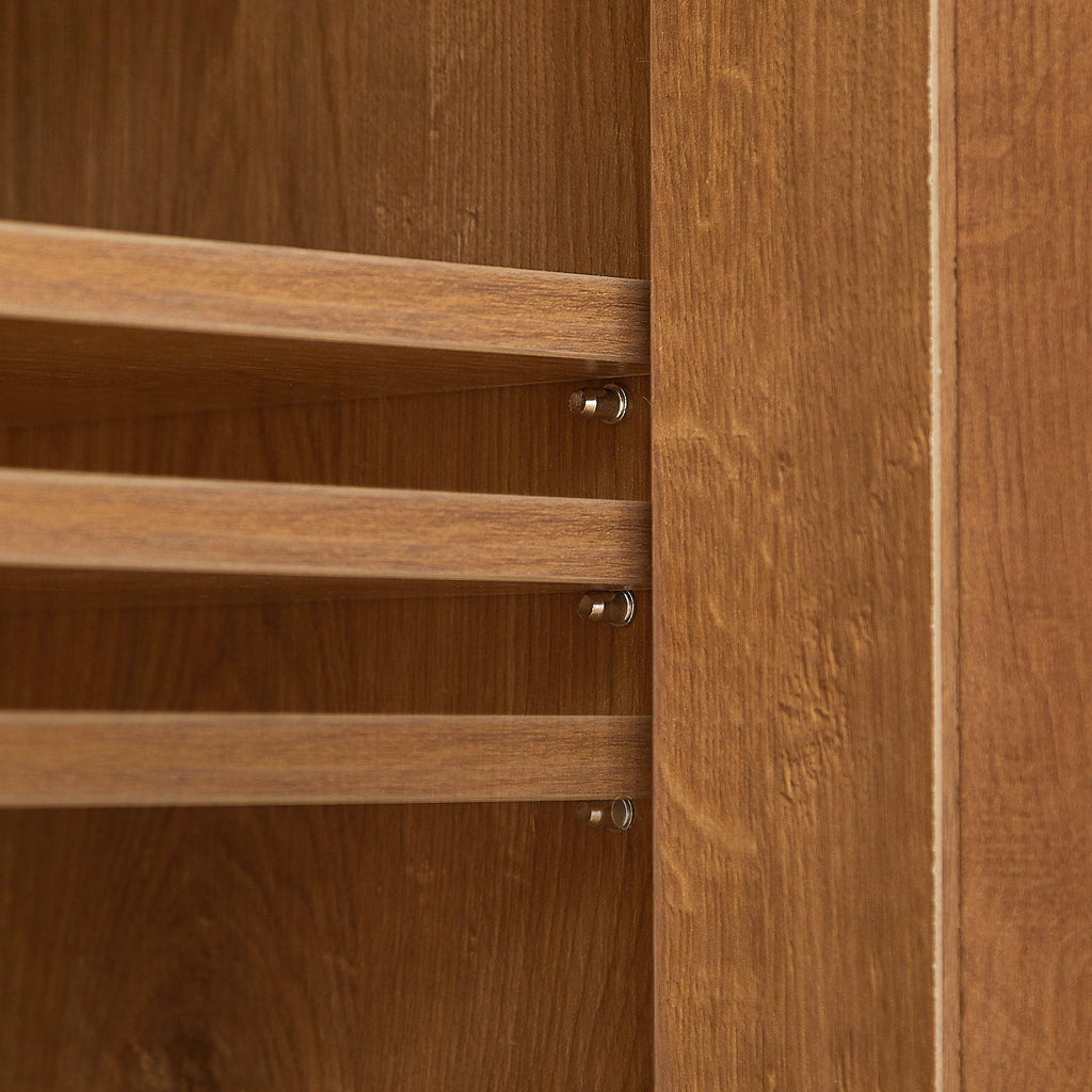 Adjustable shelf pegs inside rattan shoe cabinet allow customization of shelf height. Flexible shoe organizer for various shoe sizes.