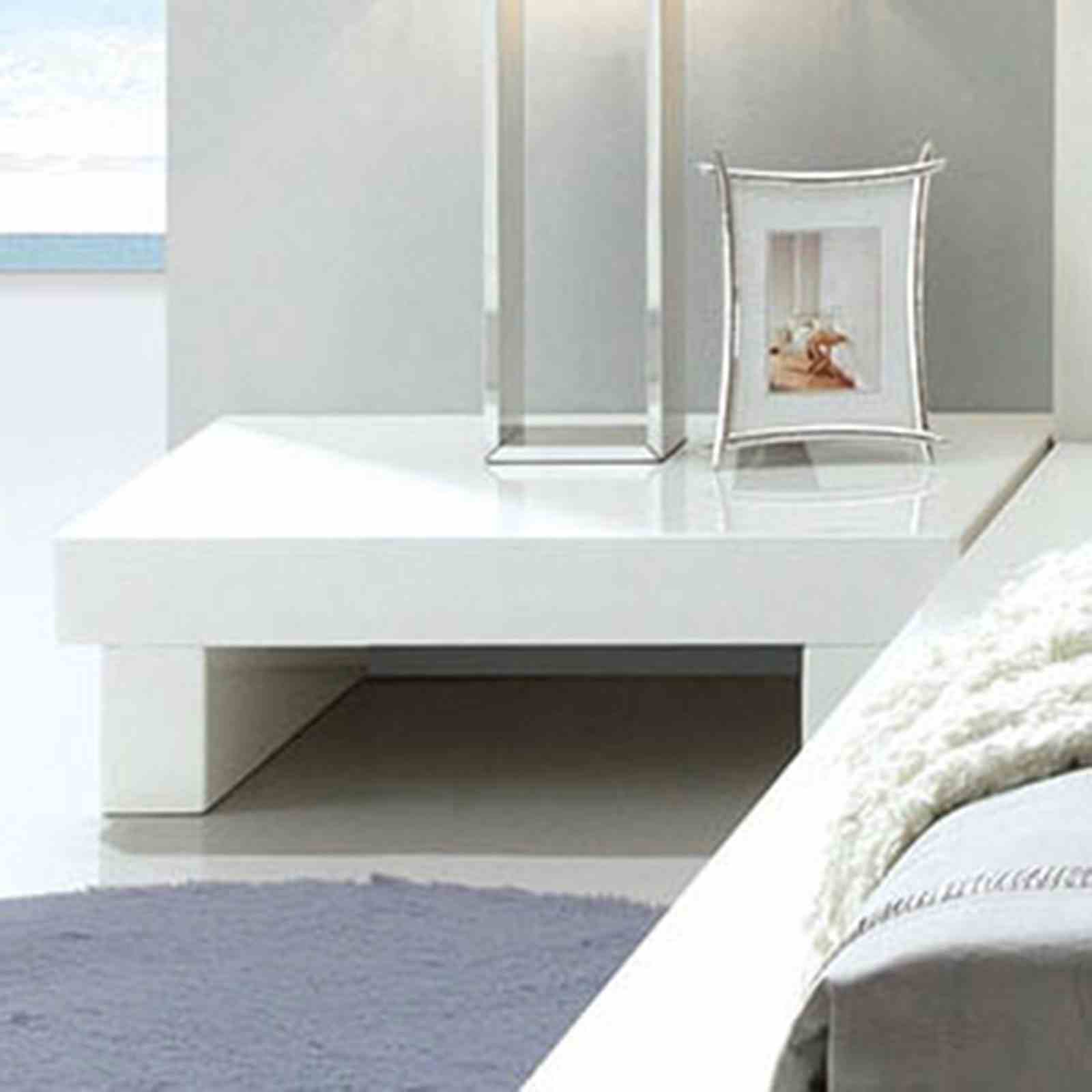 Contemporary low-profile nightstand in high-gloss white lacquer with a minimalist block design.
