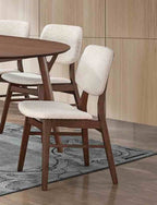 Set of mid-century dining chairs with angled legs and padded seats in a modern dining room, enhancing comfort and decor.
