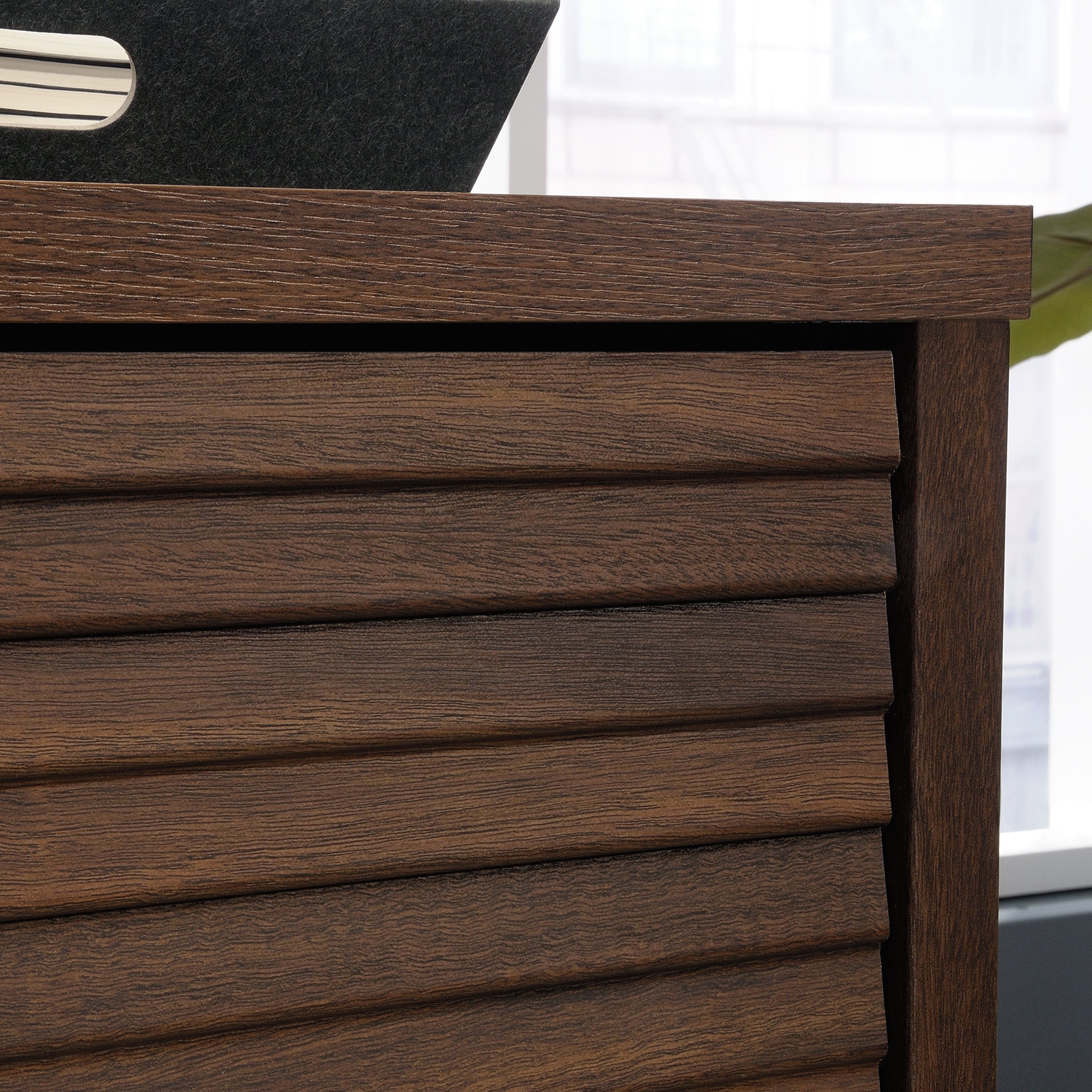 Close-up of the slatted wood texture on the Library Base, Brown finish cabinet door, highlighting its modern craftsmanship.