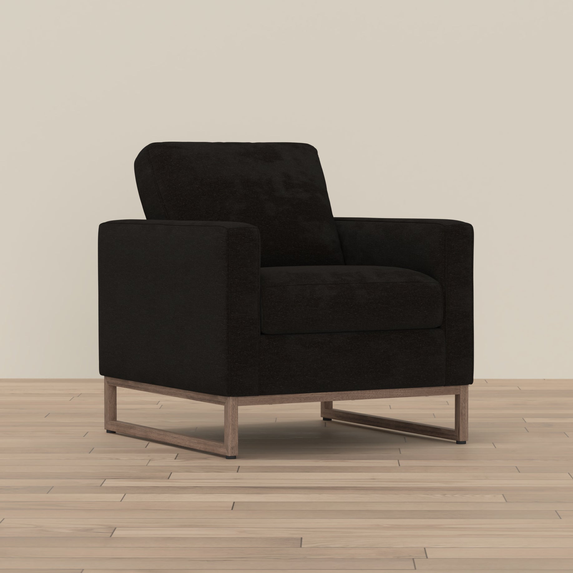 Modern black fabric accent chair with a boxy silhouette and a minimalist wood-tone metal sled base.