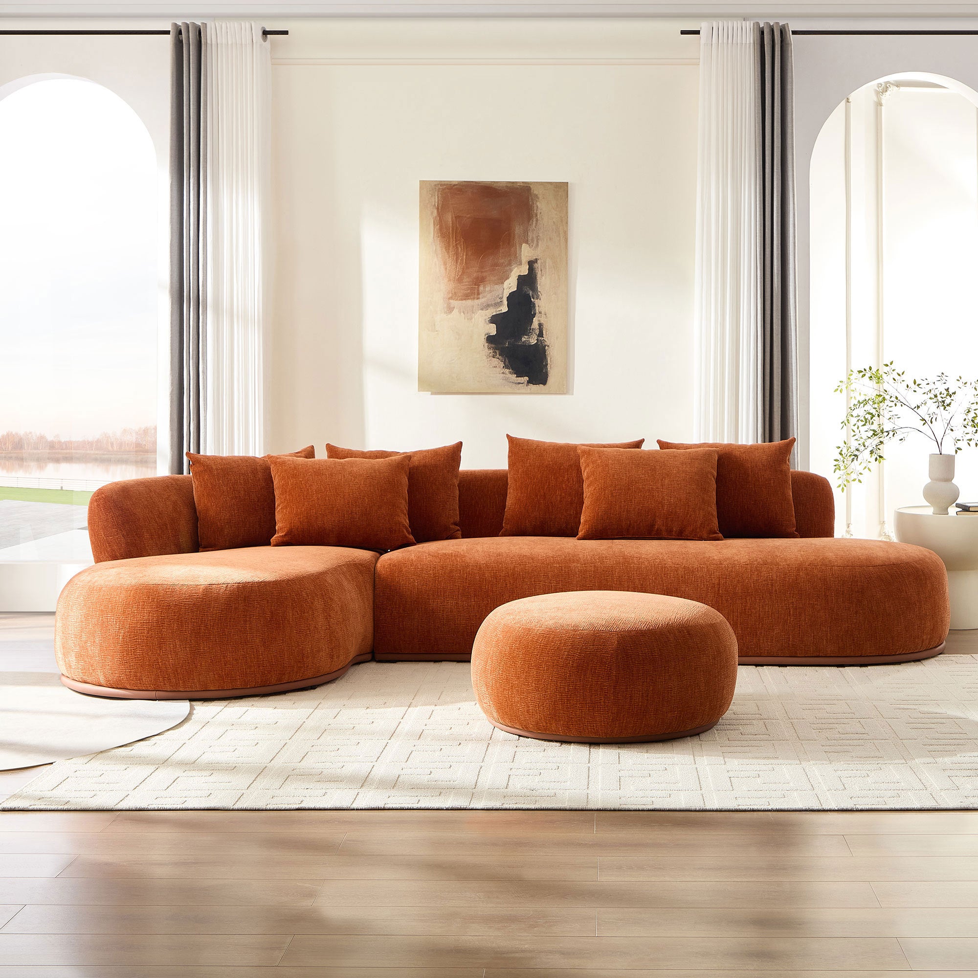 Modern orange oversized L-shape sectional sofa with ottoman in a bright living room, perfect for comfort and contemporary decor.