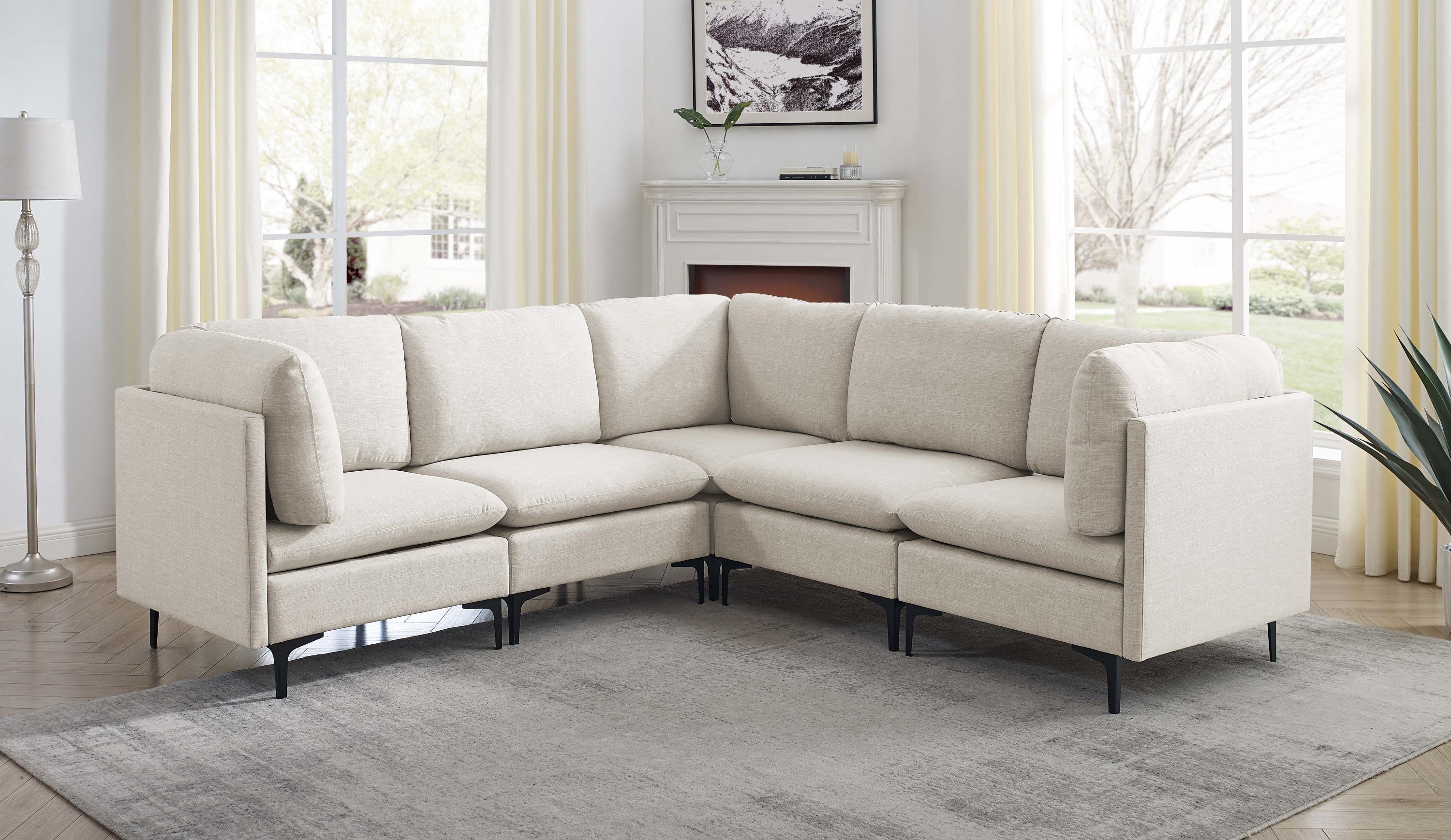 Beige modular sectional sofa upholstered in linen fabric, featuring clean lines and slim black metal legs.
