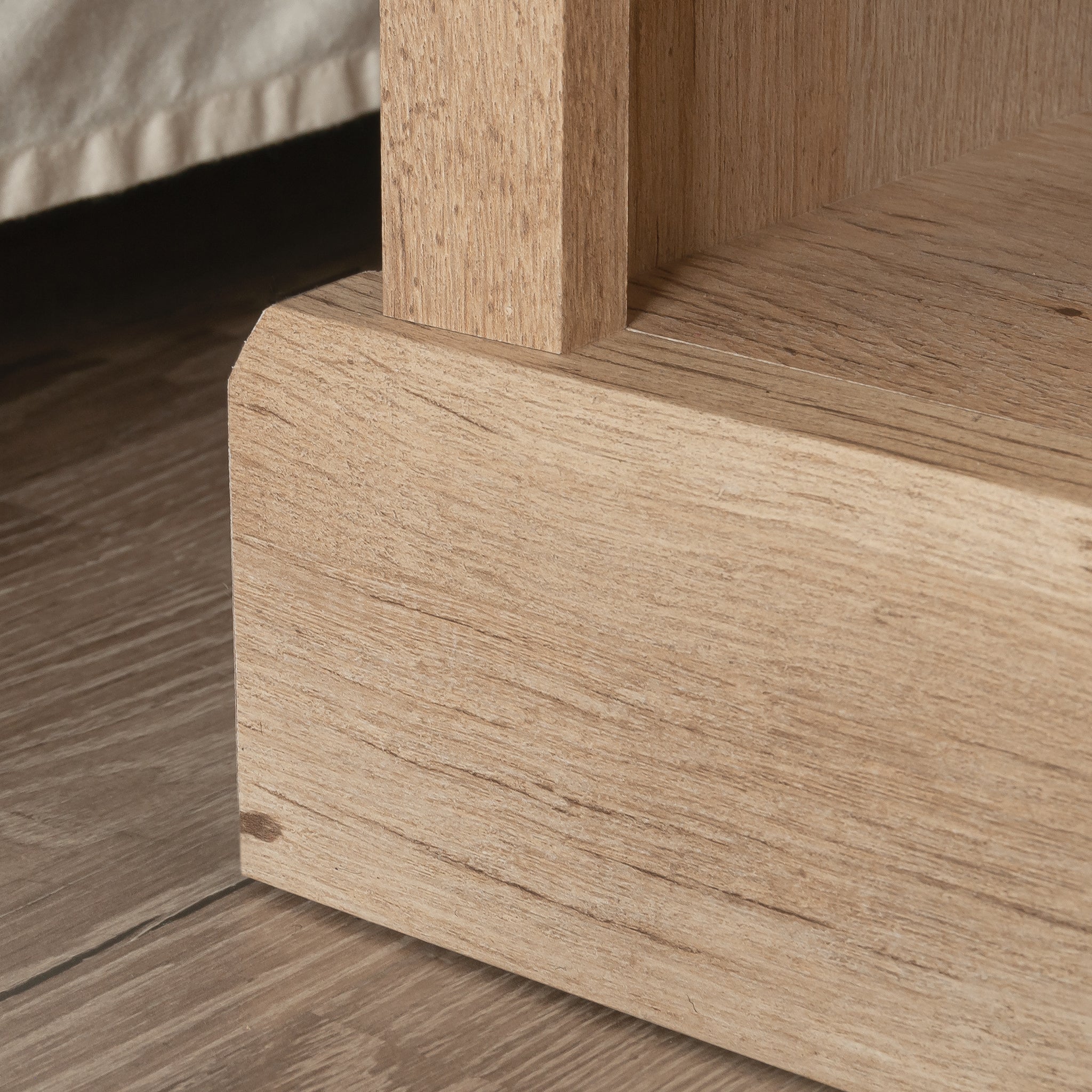 Detail of the night stand's base highlighting the sturdy wood construction and natural brown finish for a rustic furniture look.