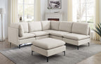 Beige linen modular sectional sofa with matching ottoman and sleek black metal legs in a bright living room.