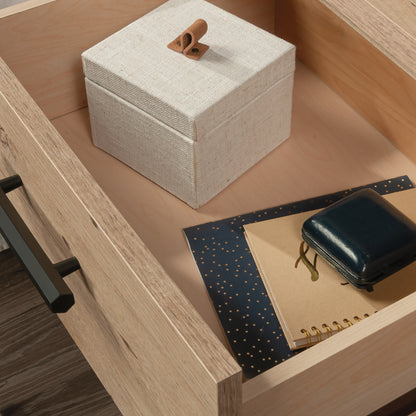 Interior view of the night stand drawer containing a fabric box and notebooks, showing spacious storage and smooth drawer lining.