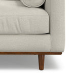 Lower front corner of Modern Armchair Cream White - Morrison Collection showing cushion seam and tapered wood leg.