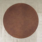 Top-down view of round Faux Burl Coffee Table placed on a textured rug, ideal for modern small-space living.