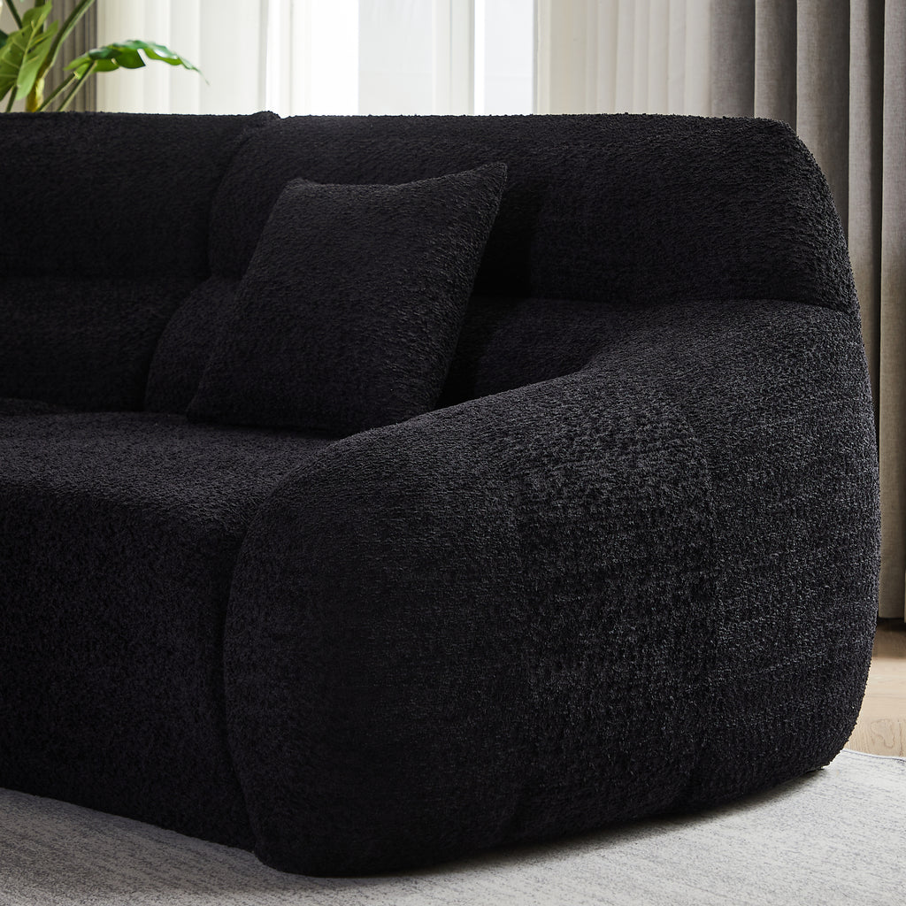 Side view of Modern Black Modular Sofa armrest with plush chenille fabric and supportive cushion, highlighting its modern curved form.