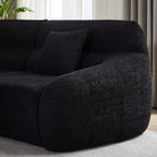 Side view of Modern Black Modular Sofa armrest with plush chenille fabric and supportive cushion, highlighting its modern curved form.