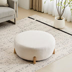 Modish Round Ottoman with Boucle Top and Natural Wood Legs.