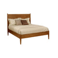 Mid-Century Modern platform bed in oak finish with full size frame, tapered legs, and slatted base, styled with neutral bedding and accent pillows.