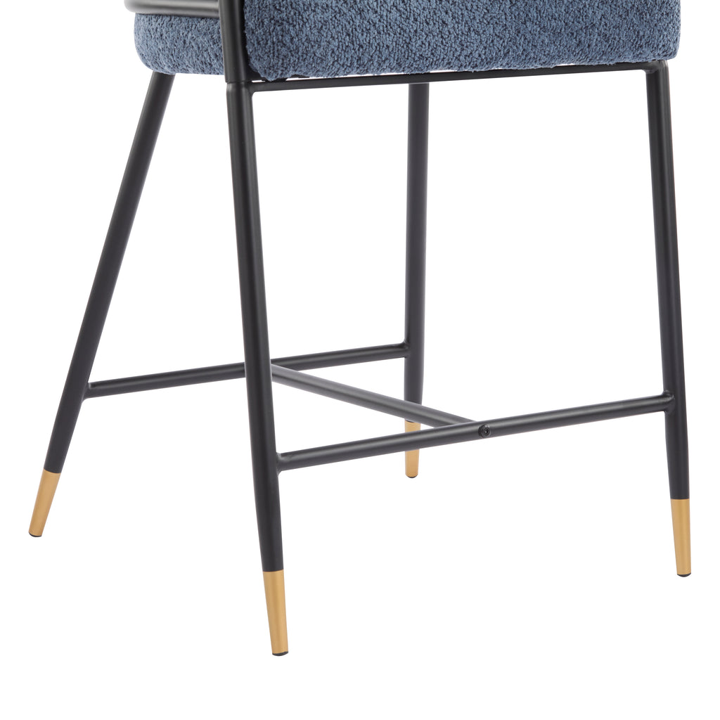 Close-up of stool legs featuring black metal construction with gold-tipped feet and a sturdy footrest bar for added comfort.