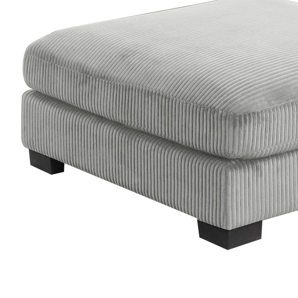 Detail of Bentley Modular Sectional Sofa ottoman base in gray corduroy, showing ribbed texture and sturdy black wood legs.