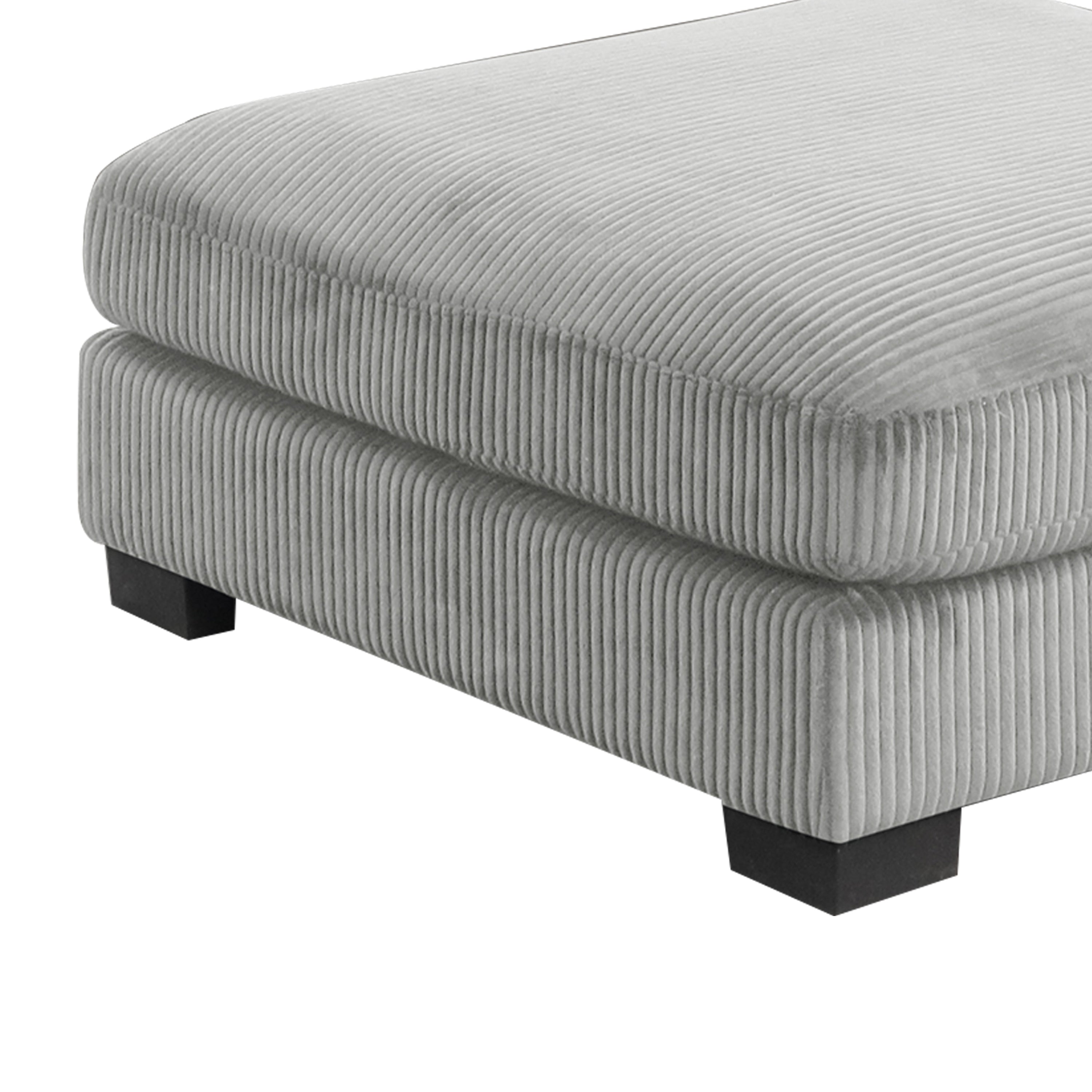 Detail of Bentley Modular Sectional Sofa ottoman base in gray corduroy, showing ribbed texture and sturdy black wood legs.