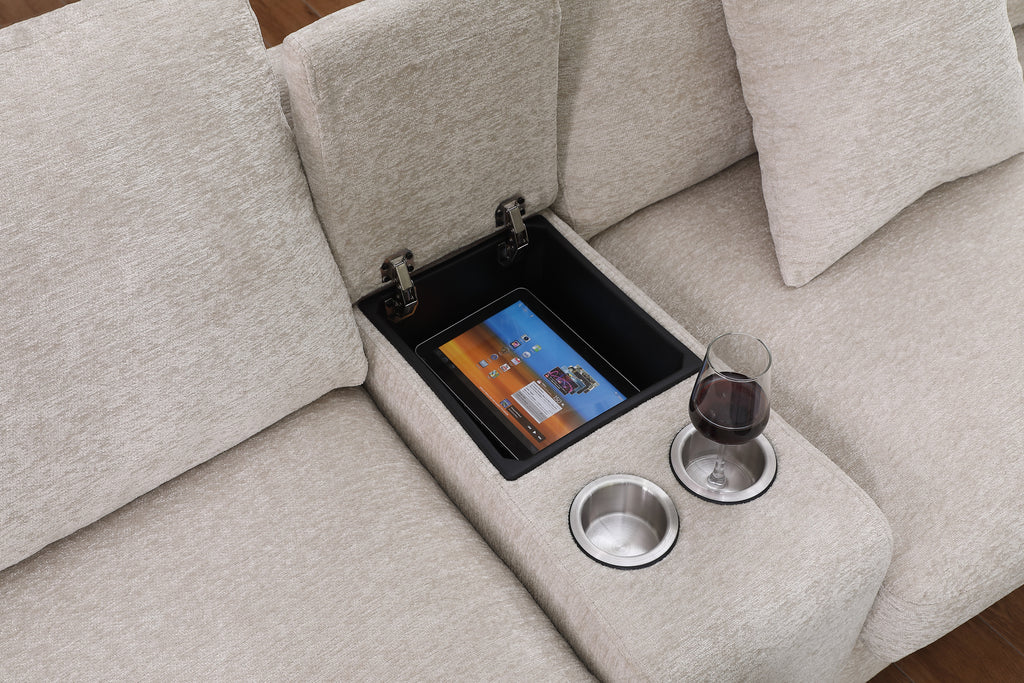 Storage compartment with tablet and cupholders on beige chenille sectional sofa, highlighting functional design features.