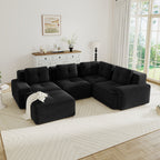 Modern black corduroy 4-seater modular sectional sofa with tufted cushions, pearl piping, and a matching ottoman.