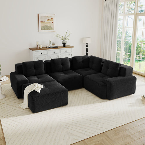Modern black corduroy 4-seater modular sectional sofa with tufted cushions, pearl piping, and a matching ottoman.