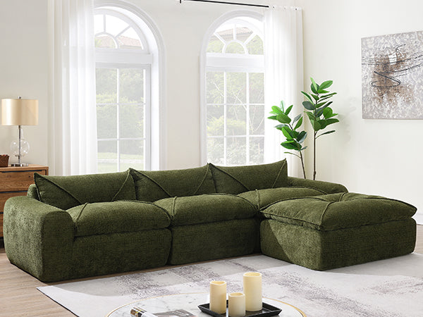 116'' compressed sofa with high density foam in green, styled in a bright living room with large windows and modern decor.