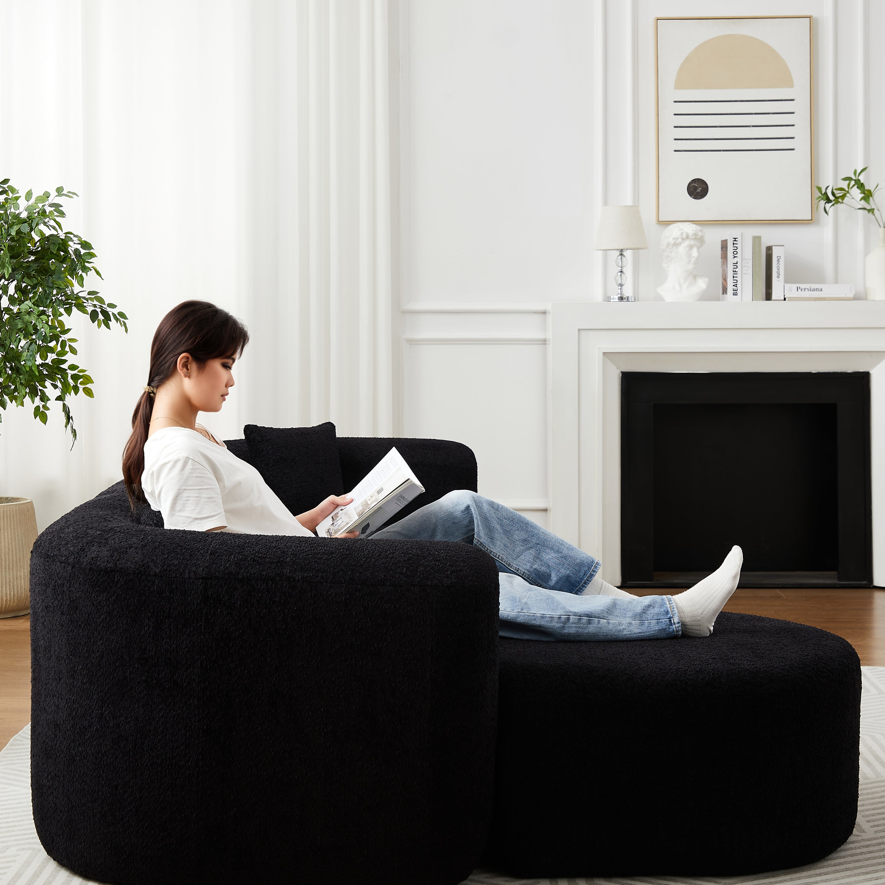 Woman relaxing on black chenille modular sectional sofa with curved back, showcasing the cloud-like comfort and spacious seating.