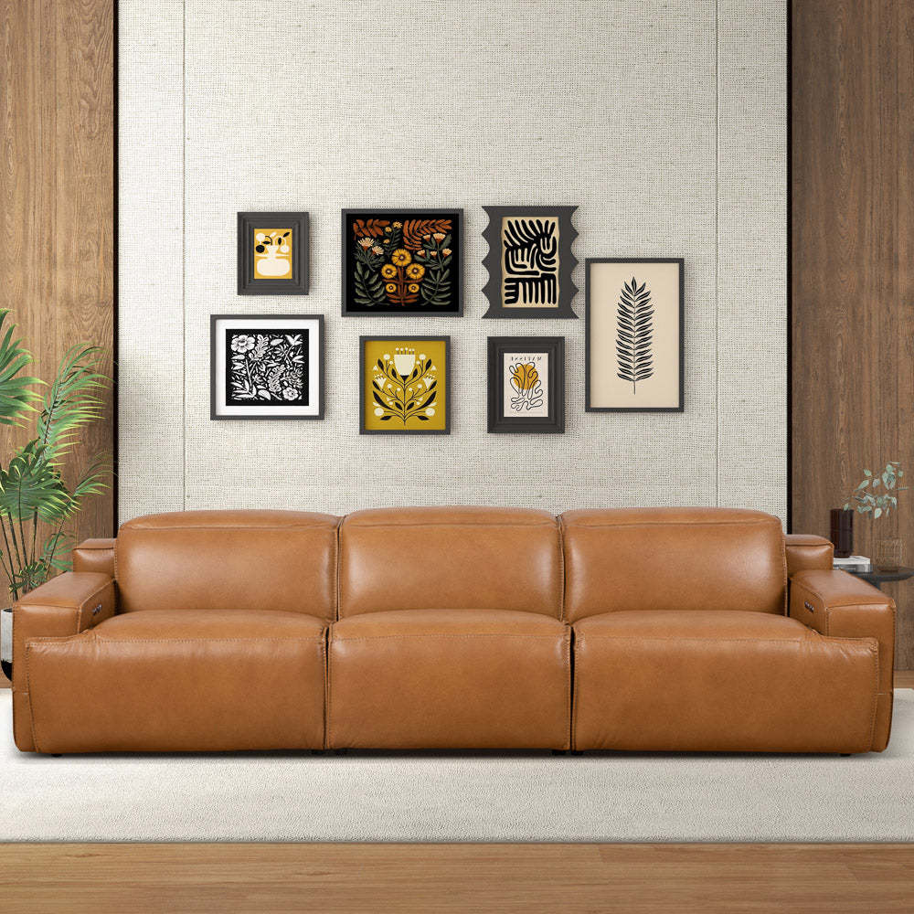 Tan leather triple power recliner sofa with clean lines and integrated control buttons on arms in a modern setting.