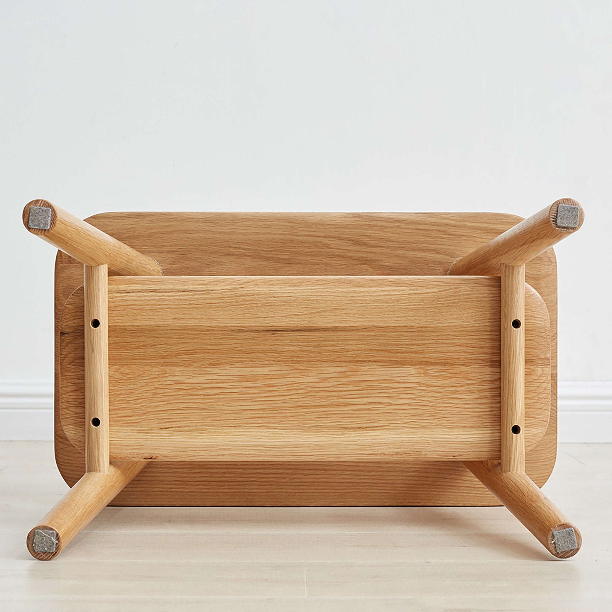 Bottom view of Solid Wood Shoe Stool showing sturdy oak construction and screw-mounted legs for durable entryway seating.