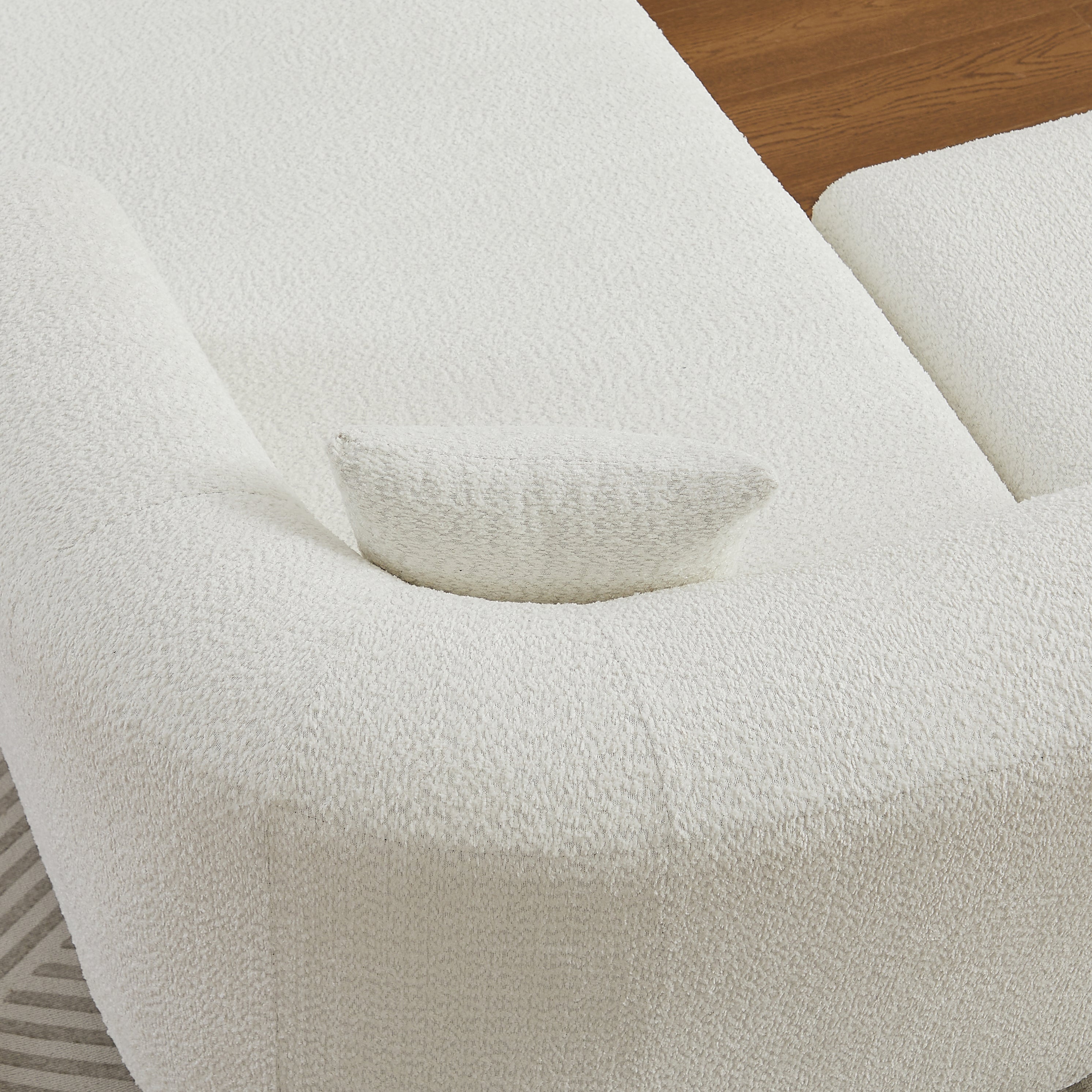 Top-down view of the armrest and cushion on the beige chenille modular sectional sofa, showing its soft and supportive design.