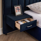 Open drawer of built-in nightstand on queen velvet bed frame showing storage space and modern handle design.